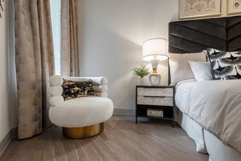 a bedroom with a bed and a chair in a 555 waverly unit